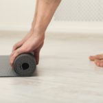 Rolling up fitness mat for exercise copy space