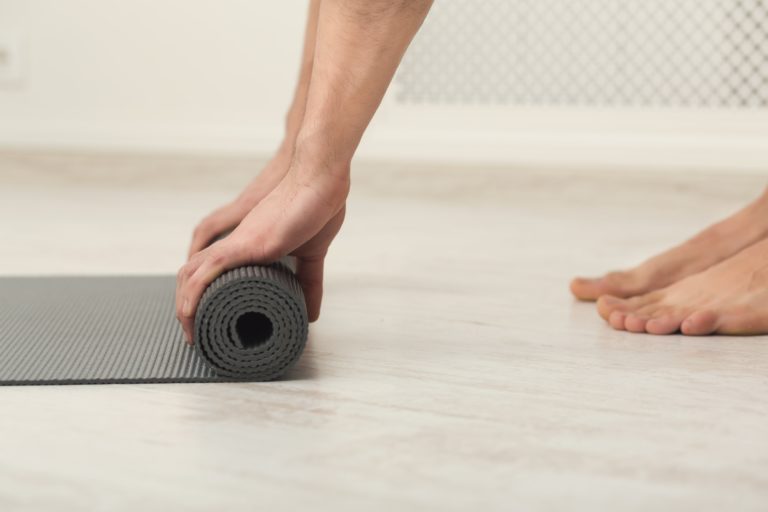 Rolling up fitness mat for exercise copy space